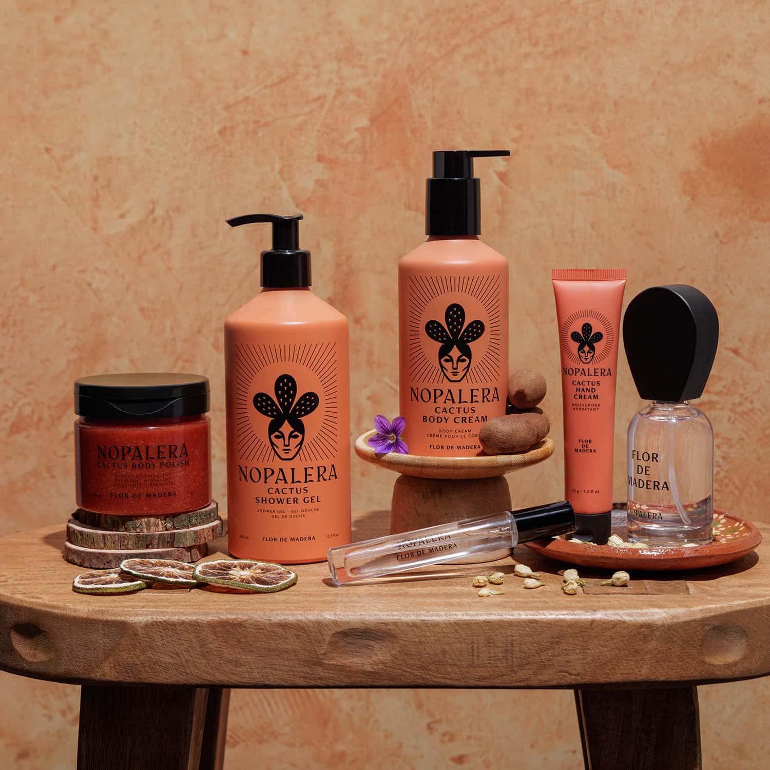Nopalera body care and fragrance collection featuring cactus body polish, shower gel, body cream, hand cream, and Flor de Madera perfume travel spray and 50 ml.
