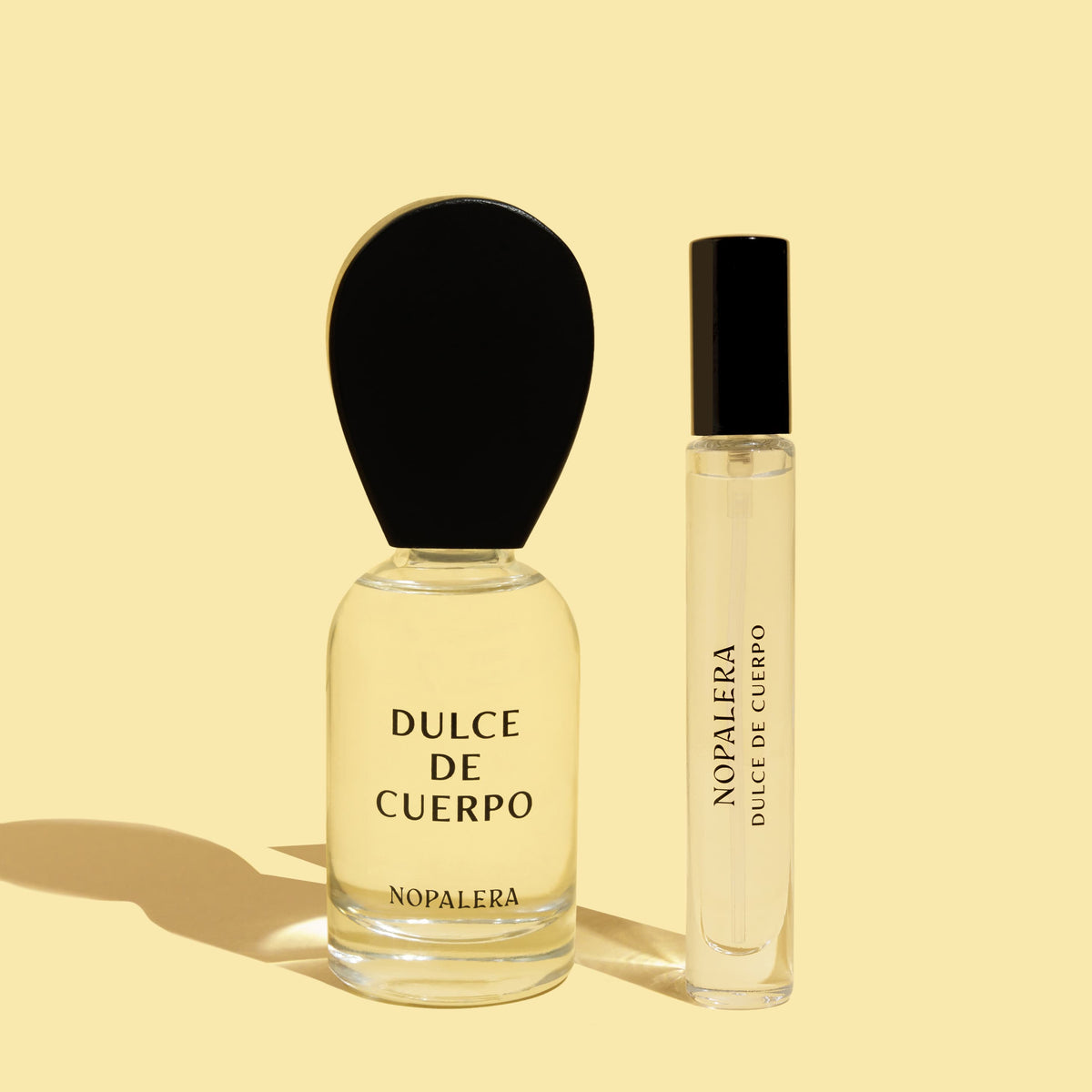 Two Nopalera Dulce de Cuerpo perfume bottles, including a 50ml Eau de Parfum and a 10ml travel spray on a beige background