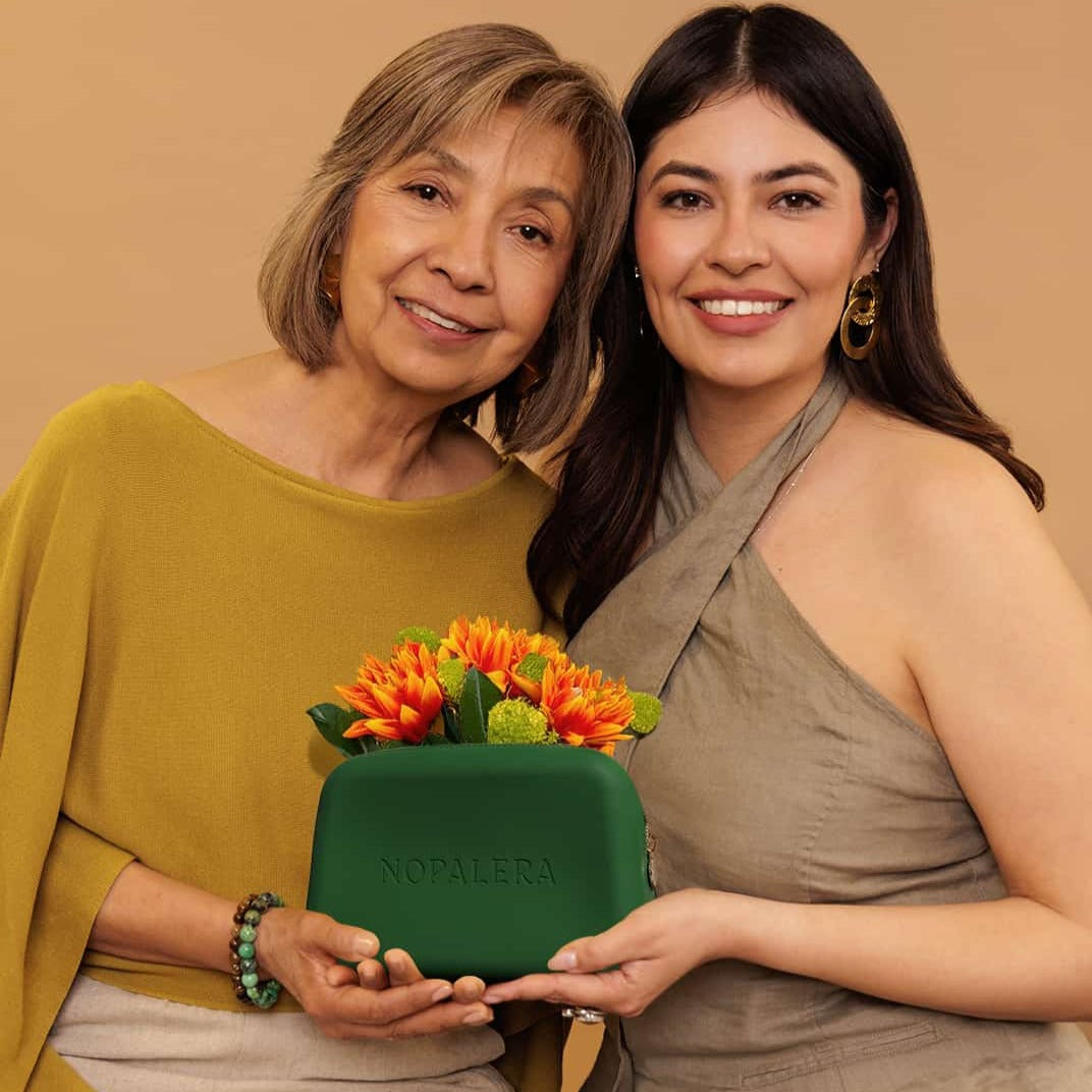 Mother's day Nopalera gift with purchase. A Green nopalera.sbssmetic pouch with gold zipper and embossed logo.