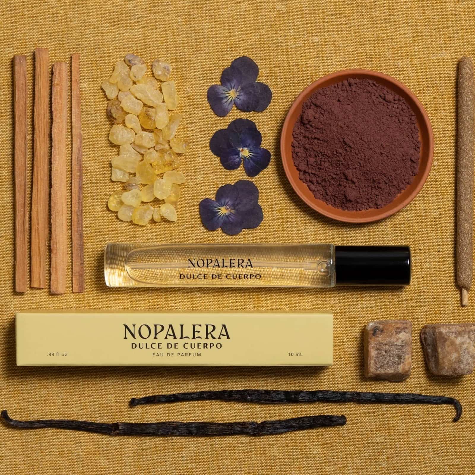 Luxury Mexican fragrance Nopalera perfume bottle and packaging with natural ingredients on a textured surface
